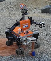 Momaro taking a soil sample at DLR SpaceBot Camp 2015